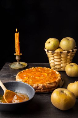 Elmalı turta, yapraklar, elmalar ve reçelli kase, seçici odak, siyah arkaplan, dikey