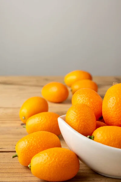 Aerial View Whole Kumquats White Bowl Wooden Table Selective Focus — Stockfoto