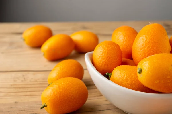 Top View Whole Kumquats White Bowl Wooden Table Horizontal Copy — Stockfoto