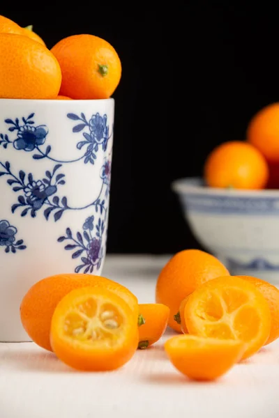 Close Orange Kumquats Bowl Flowers White Table Selective Focus Black — Stockfoto