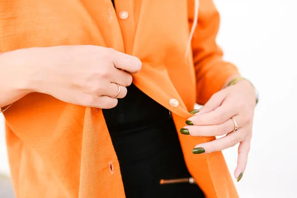 The girl takes off her clothes. Orange jacket. Fashion and style concept — Stock Photo, Image