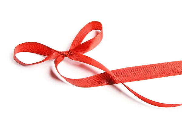 Shiny red satin ribbon and bow on white background — Stock Photo, Image