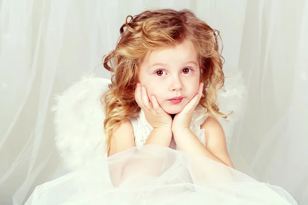 The beautiful little girl in an image of an angel Stock Photo