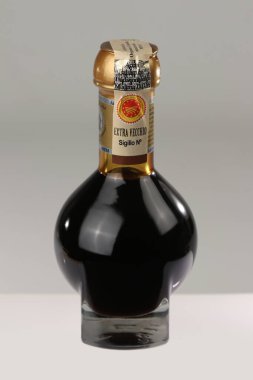 Modena, Italy, year 2022, Balsamic vinegar of Modena, Italy, official glass bottle of consortium containing special sweetening of Modena clipart