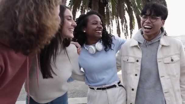 United multiracial group of millennial people laughing outdoors — Stock video