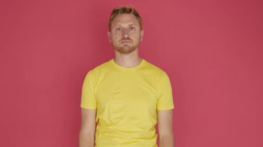 Redhead young man crossing arms and smiling at camera over isolated background