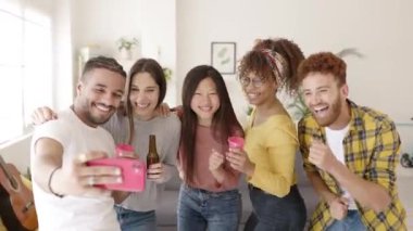 Multiethnic young friends celebrating together at home party