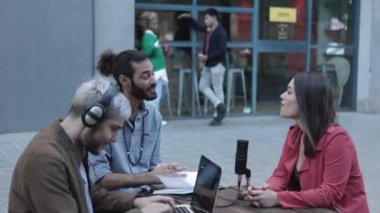 Çeşitli yetişkin blogger öğrencileri bar terasında podcast kaydediyor