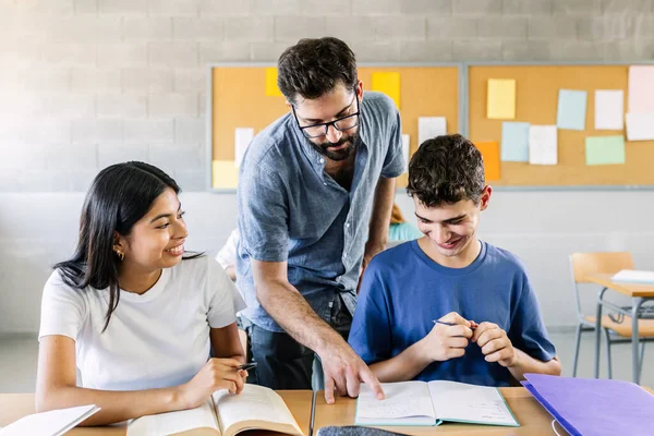 Male Teacher Helping High School Students Doing Exercises Classroom Education —  Fotos de Stock