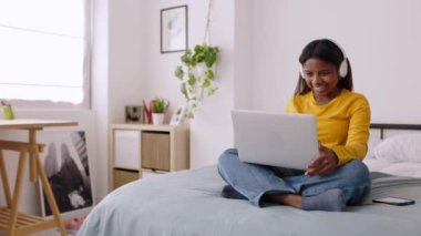 Happy young latin woman chatting with friends on laptop video call. High quality 4k footage