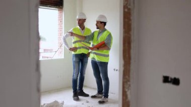 Professional engineer architect workers in conversation at building construction site