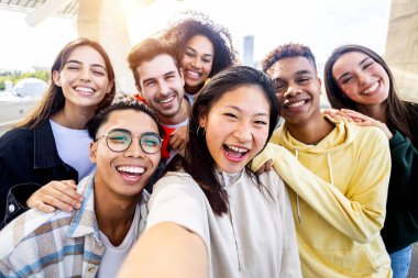 Çeşitli mutlu genç arkadaşlar selfie çekerken birlikte eğleniyorlar - uluslararası gençlik topluluğu kavramı çok ırklı gençlerin kendi fotoğraflarında gülümseyişi.