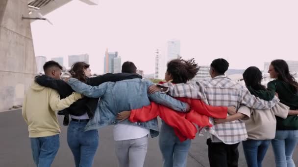 Vista Trasera Grupo Joven Diversos Mejores Amigos Abrazándose Mientras Caminan — Vídeo de stock
