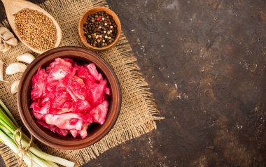 Cabbage salad with beets in a clay bowl. fermented foods. Homemade food. Sour food. Pickled vegetables. Vegetarian vegan food. Top view, flat lay. Copy space.