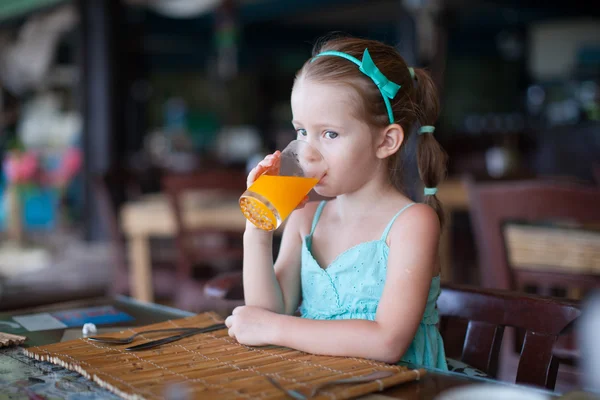 Adorable little girl having breakfast at resort restaurant — Stock Photo, Image