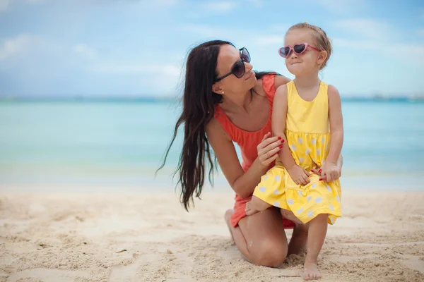 Young beautiful mother and her adorable little daughter at tropical beach Stock Picture