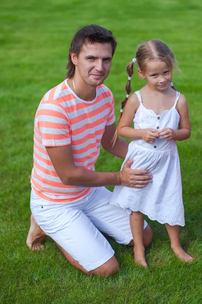Portrait of father with his daughter sitting in the yard — Stock Photo, Image
