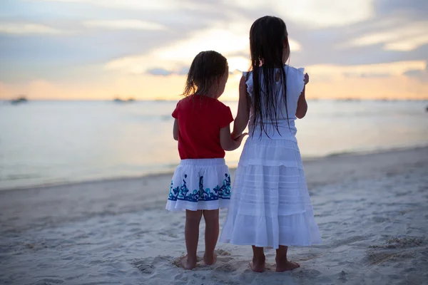 Little adorable girls in nice dress on the beach in sunset — Stock Photo, Image