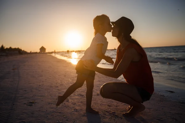 Mom and daughter silhouette in the sunset at the beach on Holbox island — Stock Photo, Image