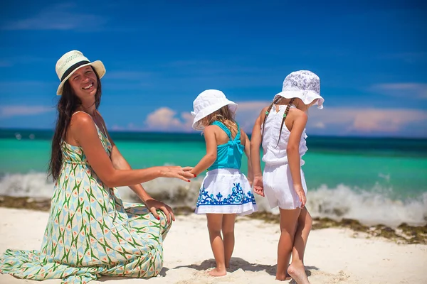 Young mother and two her fashion kids at exotic beach on sunny day — Stock Photo, Image