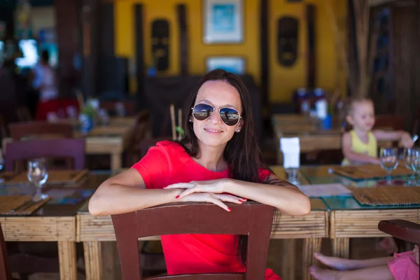 Young woman relaxing at resort restaurant — Stock Photo, Image