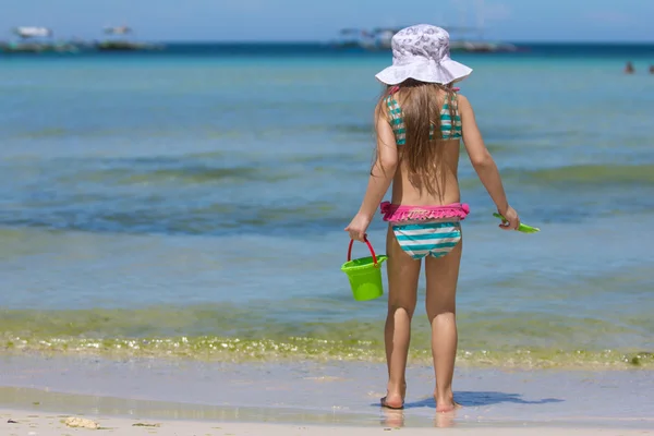 Adorable little girl in beautiful swimsuit walking at tropical — Stock Photo, Image