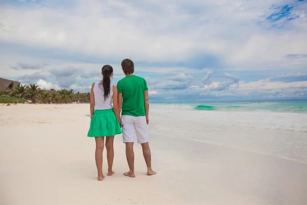 Jeune couple marchant sur une plage exotique par temps ensoleillé — Photo