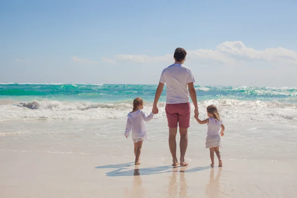 Back view of happy father and his adorable little daughters walking on sunny day — Stock Photo, Image