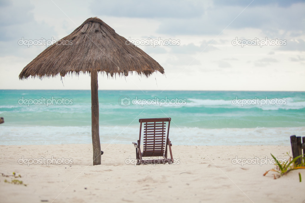 Beach lounger and umbrella on the exotic resort in Mexico