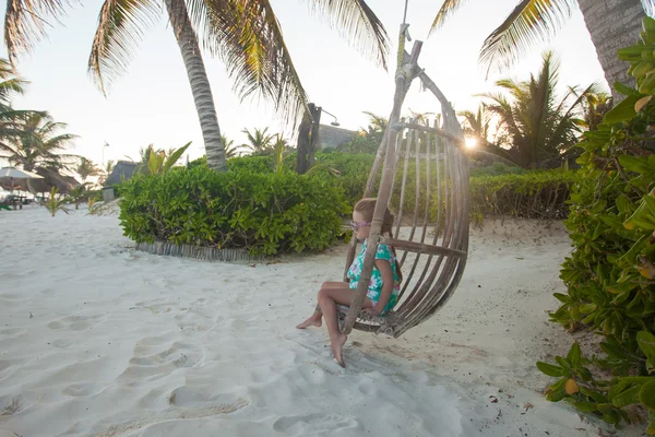 Happy little girl enjoy swing on white sandy Caribbean beach — Stock Photo, Image