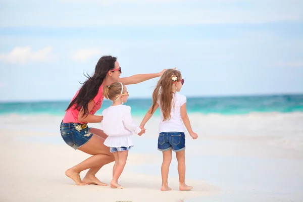 Madre joven y sus hijas lindas disfrutan de vacaciones de verano en la playa tropical —  Fotos de Stock