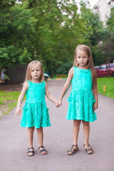 Two little fashion sister walking together on street — Stock Photo, Image