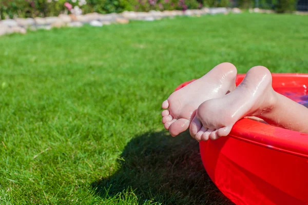 Close-up of a little girl's legs in the pool — Stock Photo, Image