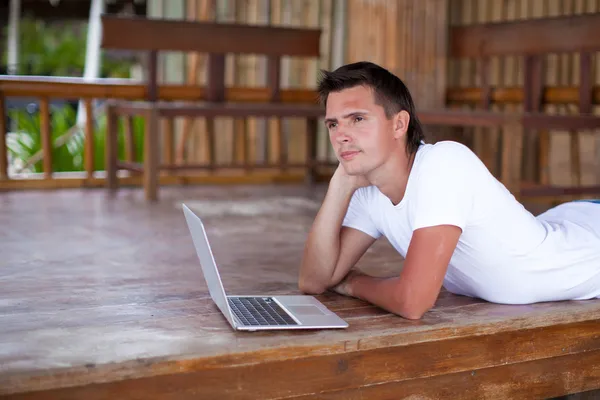 Portrait of man using tablet computer on exotic resort — Stock Photo, Image