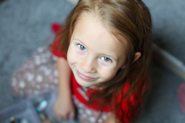 Close-up face of a beautiful blue-eyed little cute girl clipart