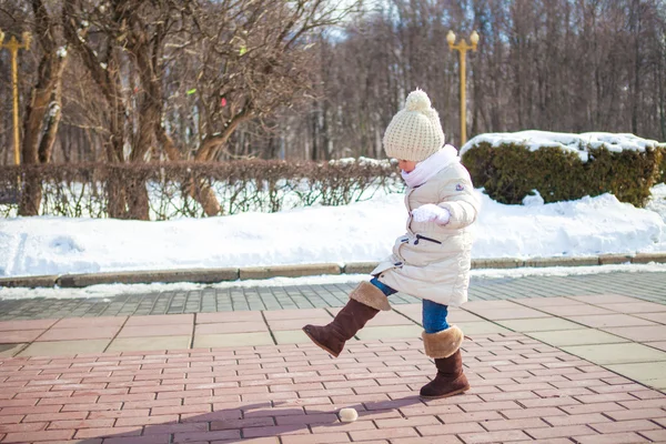 Little cute girl walks in the winter on a sunny day outdoors — Stock Photo, Image