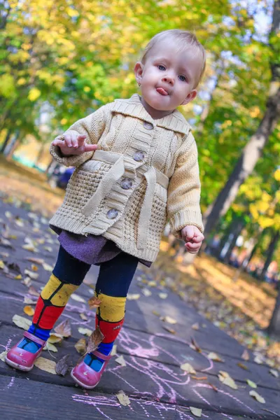 Portrait of Little beautiful girl walking alone in autumn park — Stock Photo, Image