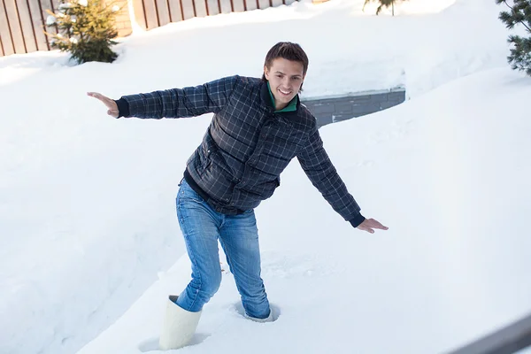 Joven hombre en botas de invierno cayó en una nieve blanca profunda —  Fotos de Stock