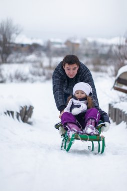 genç bebek kızı sleigh Ride ile baba ve güneşli kış iyi günler