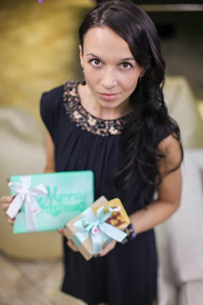 Beautiful young girl with Christmas present in hands — Stock Photo, Image