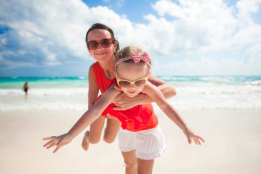 sevimli kızı annesiyle keyfini çıkarın tatil ve Meksika plajda eğlenmek
