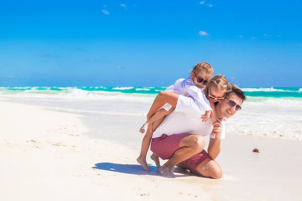 Joven padre feliz y pequeñas hijas divirtiéndose en la playa blanca en el día soleado —  Fotos de Stock