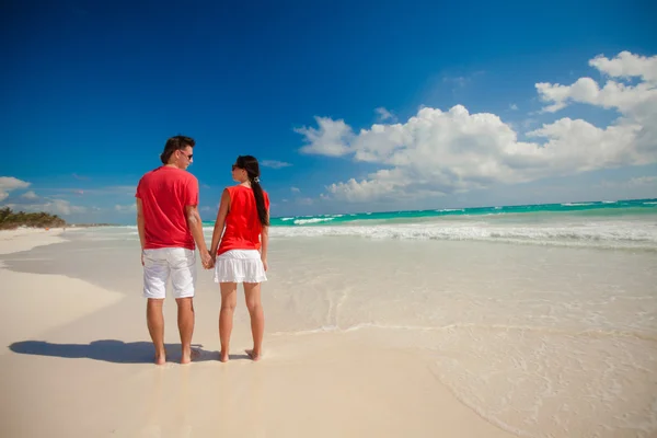 Vue arrière d'un jeune couple jouissant l'un de l'autre sur une plage tropicale — Photo