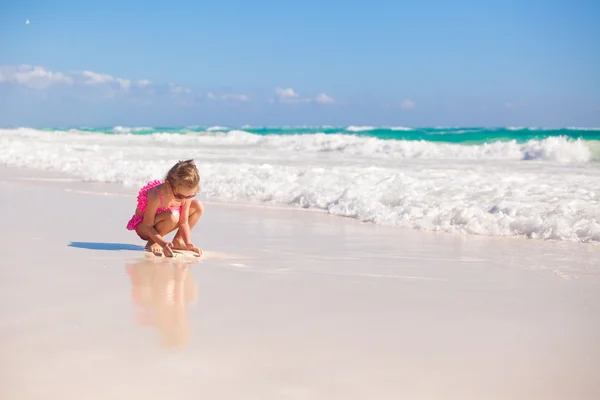 Adorabile bambina in costume da bagno sulla spiaggia di carrube tropicale — Foto Stock