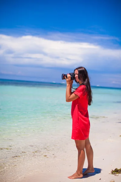 Profile of young nice woman photographed beautiful seascape on white sand beach — Stock Photo, Image