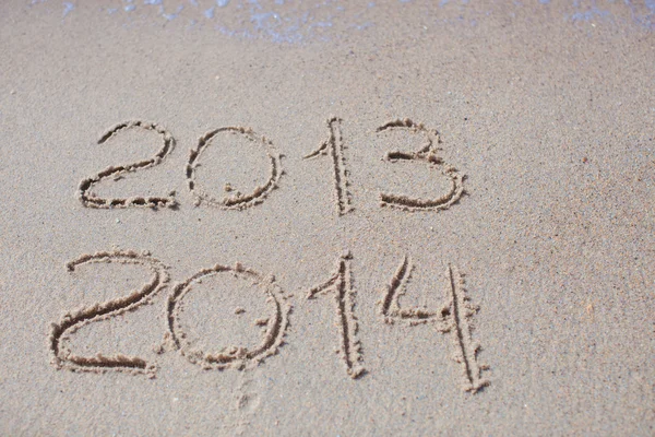 2012 and 2013 written in sand on beach — Stock Photo, Image