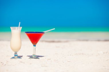 İki kokteyl: pina colada ve beyaz kum plaj çilek margarita