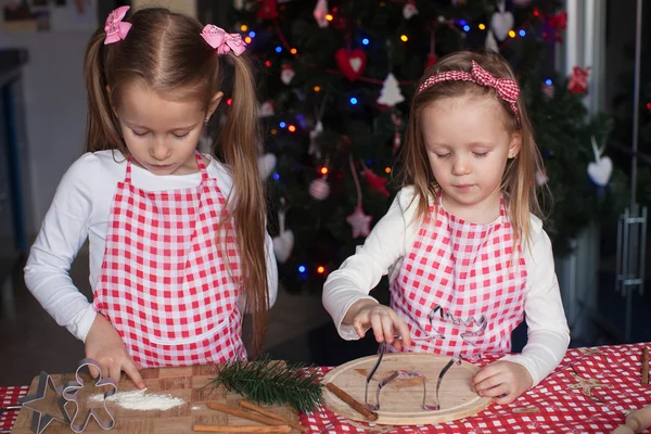 Little cute sisters bake gingerbread cookies for Christmas — Stock Photo, Image