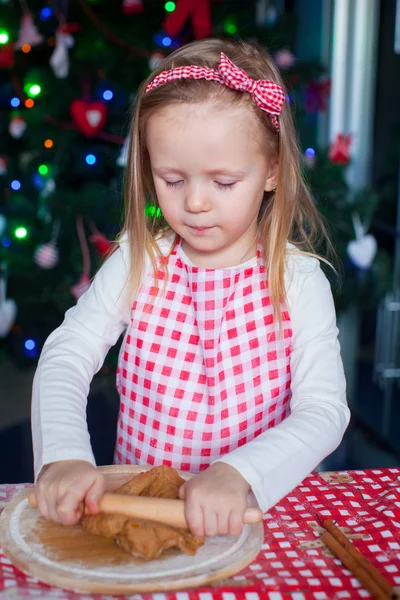 Little happy girl with rolling pin baking gingerbread cookies for Christmas — Stock Photo, Image
