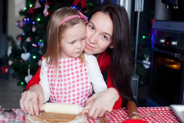 Little adorable girl and young mother baking Christmas gingerbread cookies — Stock Photo, Image